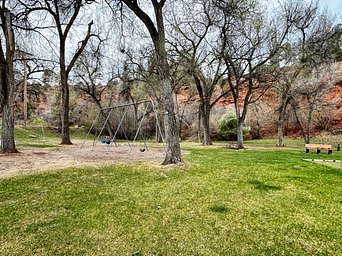 Swing set and picnic table at public park in Hot Springs, SD on Cold Brook Ave.