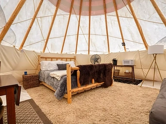 Inside a glamping teepee / tipi rental in the Black Hills at Highland Meadows Resort.