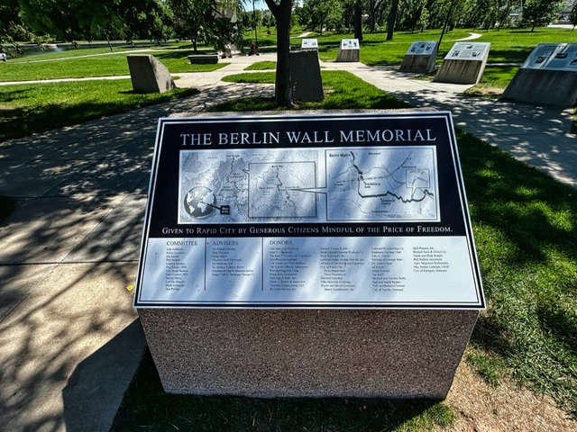 The plaque with historic information about the Berlin Wall Memorial in Rapid City, SD.