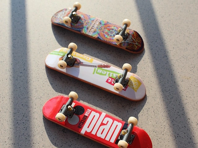 Three skateboards in a skate park.