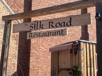 Sign for Silk Road Experience on River Street in Hot Springs, South Dakota. Pakistani restaurant with curry.