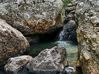 A pool of water in the rocks along the trailside of Sunday Gulch Trail in Custer State park. Trailhead at Sylvan Lake.