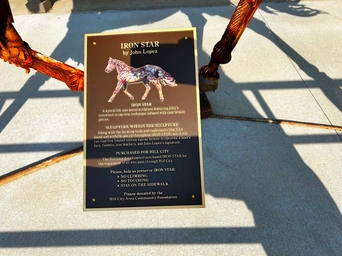 The historic plaque on the Iron Star horse statue on Main Street in Hill City South Dakota.
