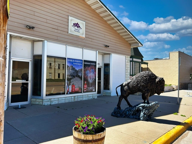 Front of Khantong Thai Cuisine restaurant in Edgemont, SD, Bison statue and flowers out front.