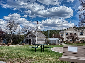 Dr. Flick historic cabin set at the back of Way Park in downtown Custer, SD.