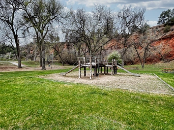 Playground against red cliffs in Hot Springs, South Dakota - on Cold Brook Ave.