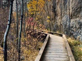 Wooden walkway behind Sylvan Lake in the fall. Black Hills Trails.