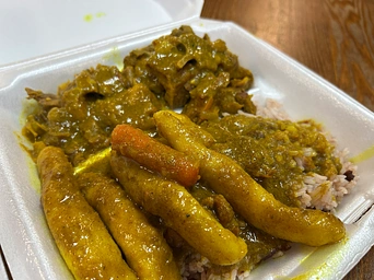 Goat curry with rice and dumplings at A&D Jamaican food in Rapid City, South Dakota. Authentic menu.