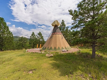 Authentic teepee at Highland Meadows Resort surrounded by Ponderosa Pines in Hot Springs, SD.