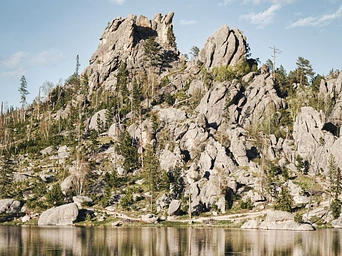 Stockade Lake, location of the Custer State Park Spur Trail in the Black Hills. Rocks with reflections.