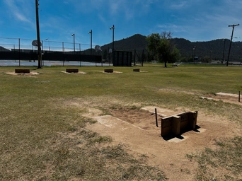 The horseshoe pits at Butler Park in Hot Springs, SD. Basketball court in the background.