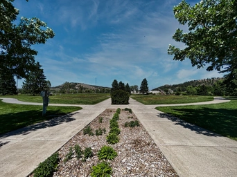 The William Nordemeer Park in Rapid City, SD. Parallel sidewalks lead toward the giant sundial.