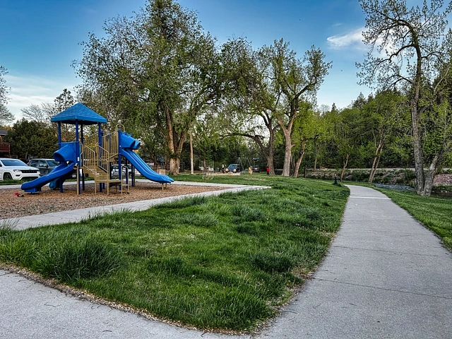 Brookside Park along the Freedom Trail in Hot Springs, South Dakota. Playground, sidewalk, and grass.