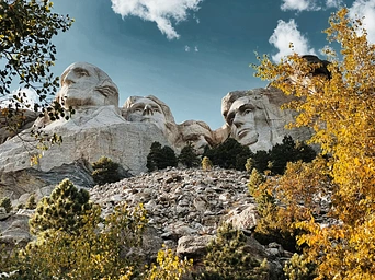 Mount Rushmore National Monument with fall foliage as seen from the trail.