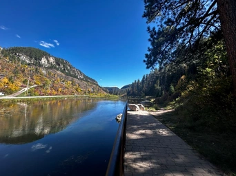 The Savoy fishing pond, rail, and walkway at the hiking trailhead in Spearfish Canyon, SD.