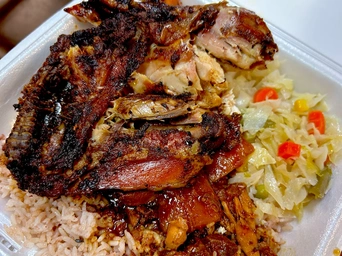 Jerk chicken with a side of rice and peas, cabbage and vegetables from A&D Jamaican in Rapid City. Most popular menu item.