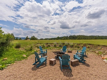 Fire pit with relaxing Adirondack chairs at Highland Meadows Resort in Hot Springs, South Dakota.